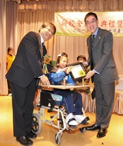 The Club's Executive Director, Charities, Douglas So (right) was presented a souvenir by The Mental Health Association of Hong Kong Executive Committee Chairman Dr Lo Tak-lam (left) and a student representative, as a token of thanks for the Club!|s donation to enhance the facilities of Cornwall School.