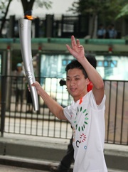 Photos 1/2:
Matthew Chadwick, 2008/09 Champion Apprentice, represents The Hong Kong Jockey Club as torchbearer in the 2009 East Asian Games Torch Relay.  He runs with the torch along Nathan Road.  

