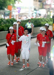 Photos 1/2:
Matthew Chadwick, 2008/09 Champion Apprentice, represents The Hong Kong Jockey Club as torchbearer in the 2009 East Asian Games Torch Relay.  He runs with the torch along Nathan Road.  
