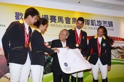 The Hong Kong Equestrian Team members present a souvenir to Club Chairman John C C Chan, thanking the Club for its continued support towards them so that the team can concentrate on preparations for the Games.