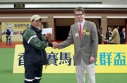 The Hong Kong Jockey Club Community Trophy Donor Mr Tobias Brown (right) presents the Best Turned Out Horse award to the winning stables assistant of Jamesina.