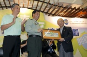 Accompanied by HKAYD Chairman Bunny Chan (left), Commander of the People's Liberation Army Hong Kong Garrison Lieutenant General Zhang Shibo (centre) presents a certificate of appreciation to Club Chairman Dr John C C Chan.

