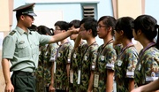 Photos 7/8: The People's Liberation Army provides foot drill training for the participants.