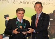 In recognition of the Club!|s huge contribution to the Hong Kong SAR equestrian team, President of Hong Kong Equestrian Federation Dr Simon Ip (right) presents a souvenir to Club Chairman T Brian Stevenson. The Club has donated HK$ 2.2 millions to Hong Kong Equestrian Federation to assist in their preparation for the Asian Games.
