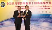 Hong Kong Jockey Club Chairman T Brian Stevenson (left) presents a token of appreciation to keynote speaker Tsang Yok-sing.