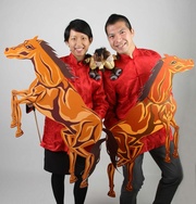 Dressed in traditional Chinese costumes adorned by a lovable horse 