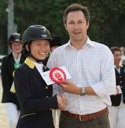 Taylor Yeung (left), who has also been named the individual champion in the show jumping competition, receives the grand prize from Sacha Eckjans (right), Manager, Equestrian Affairs of the Club. 
