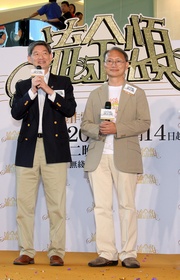 The Hong Kong Jockey Club!|s Executive Director, Charities, William Y Yiu (left) explains at today!|s launch ceremony that CADENZA is a far-sighted initiative with the aims of disseminating positive ageing messages and helping the community become better prepared for the future with an ageing population.  Pictured on the right is Acting Deputy Director of Broadcasting Tai Keen-Man.