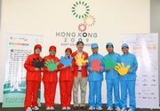 The Hong Kong Jockey Club's Executive Director, Charities, William Y Yiu (centre) and six East Asian Games volunteers unveil the new uniform to the media.