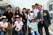 Photo 1/Photo 2: The Hong Kong Jockey Club's Executive Director of Corporate Development Kim Mak meets young disabled victims at the photo exhibition and encourages them to take a proactive approach to facing adversities in future.