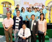 The Club!|s Executive Director, Charities, Legal & Corporate Secretariat, Douglas So (1st row, 2nd from left); Lo Wing-man, Member of Sham Shui Po District Council (1st row, 2nd from right); Charles Leung, Assistant District Social Welfare Officer (Sham Shui Po) (1st row, centre); Tai Keen Man, Assistant Director (Radio) of RTHK (1st row, 1st from left); and Yeung Pui-yee, Occupational Therapist of The Chinese University of Hong Kong (1st row, 1st from right) pictured with the Hong Kong Can Do Exercise performing group, who include members of the Club!|s CARE@hkjc Volunteer Team and representatives from the Friends of Hoi Lai Society.