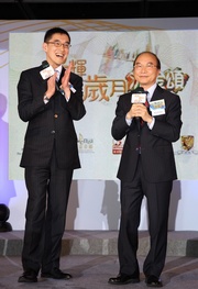 The Club's Executive Director, Charities, Legal & Corporate Secretariat, Douglas So (left), and Director of Broadcasting Franklin Wong (right) review previous 18-District Programme events with the audience.